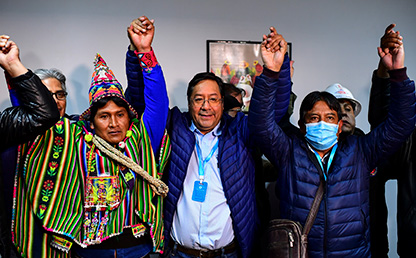 Luis Arce, presidente electo de Bolivia, levanta las manos celebrando su victoria.