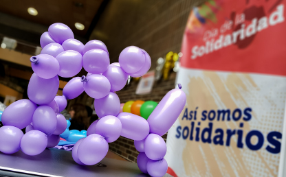 Figuras en globo con afiche: Día de la Solidaridad