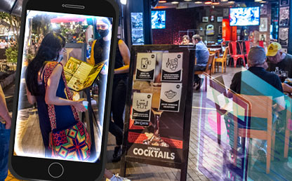 Personas revisando un menú antes de entrar a un restaurante 