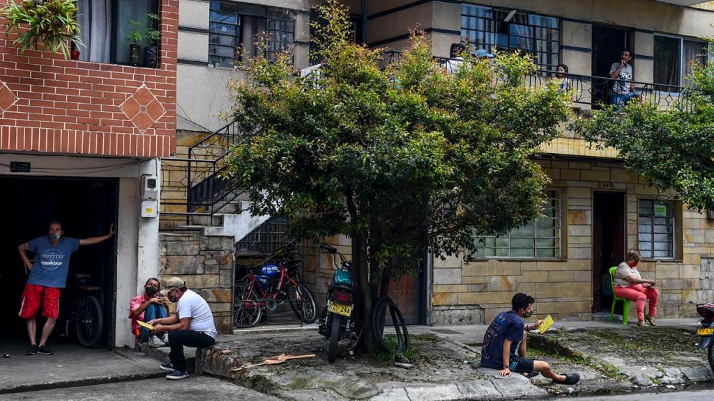Apartamentos y casa con personas asomadas